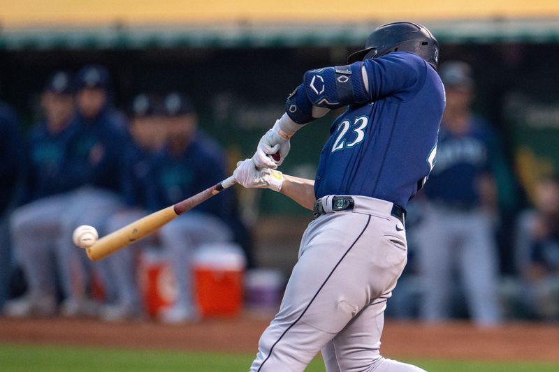 Sep 19, 2023; Oakland, California, USA; Seattle Mariners first baseman Ty France (23) hits a single during the second inning against the Oakland Athletics at Oakland-Alameda County Coliseum. Mandatory Credit: Neville E. Guard-USA TODAY Sports