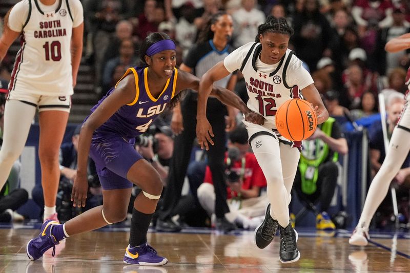 Mar 10, 2024; Greensville, SC, USA; South Carolina Gamecocks guard MiLaysia Fulwiley (12) steals the ball from LSU Lady Tigers guard Flau'jae Johnson (4) during the second half at Bon Secours Wellness Arena. Mandatory Credit: Jim Dedmon-USA TODAY Sports