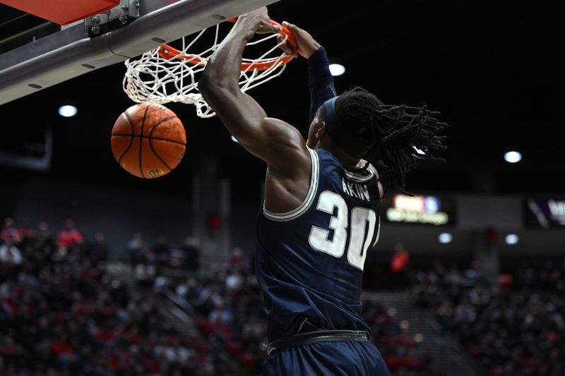 Jan 25, 2023; San Diego, California, USA; Utah State Aggies forward Dan Akin (30) dunks the ball during the second half against the San Diego State Aztecs at Viejas Arena. Mandatory Credit: Orlando Ramirez-USA TODAY Sports