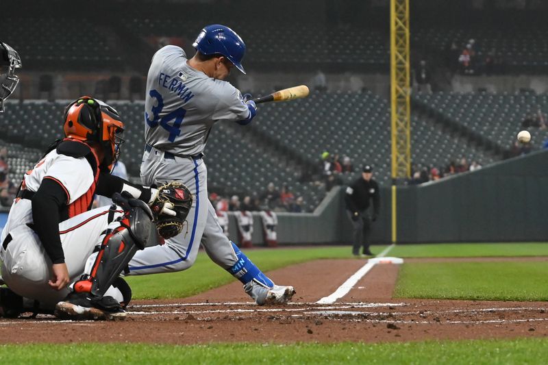 Apr 2, 2024; Baltimore, Maryland, USA;  Kansas City Royals catcher Freddy Fermin (34) hits a single to left field during the second inning against the Baltimore Orioles at Oriole Park at Camden Yards. Mandatory Credit: Tommy Gilligan-USA TODAY Sports