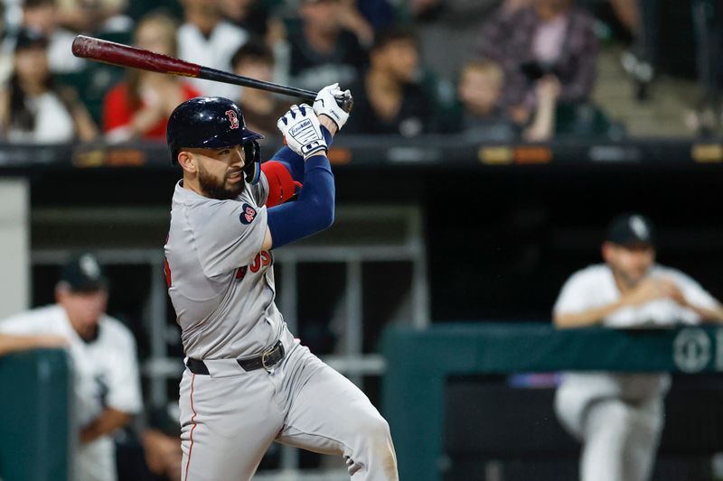 Jun 6, 2024; Chicago, Illinois, USA; Boston Red Sox catcher Connor Wong (12) hits an RBI-single against the Chicago White Sox during the sixth inning at Guaranteed Rate Field. Mandatory Credit: Kamil Krzaczynski-USA TODAY Sports