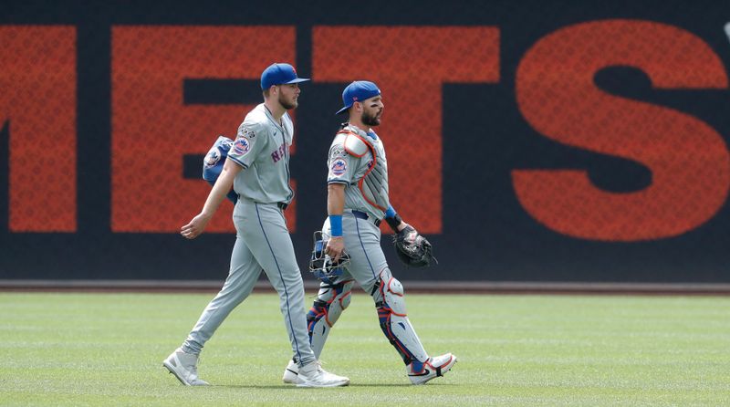 Jul 8, 2024; Pittsburgh, Pennsylvania, USA;  New York Mets starting pitcher Christian Scott (left) and catcher Luis Torrens (13) make their way in from the bullpen to play the Pittsburgh Pirates at PNC Park. Mandatory Credit: Charles LeClaire-USA TODAY Sports