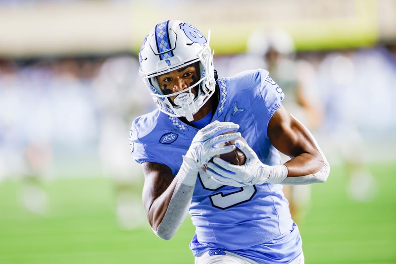 Oct 21, 2023; Chapel Hill, North Carolina, USA; North Carolina Tar Heels wide receiver J.J. Jones (5) runs after a catch against the Virginia Cavaliers in the second half at Kenan Memorial Stadium. Mandatory Credit: Nell Redmond-USA TODAY Sports