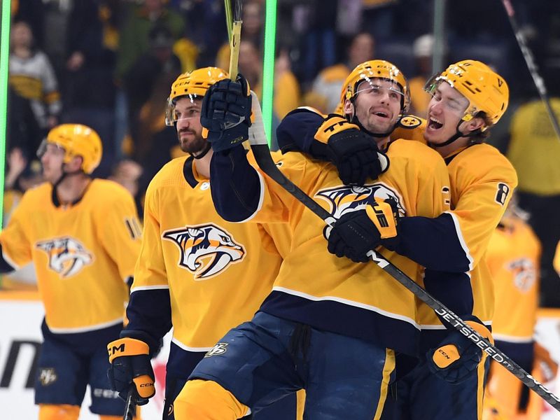 Jan 21, 2023; Nashville, Tennessee, USA; Nashville Predators left wing Cole Smith (36) and center Cody Glass (8) celebrate after a win against the Los Angeles Kings at Bridgestone Arena. Mandatory Credit: Christopher Hanewinckel-USA TODAY Sports