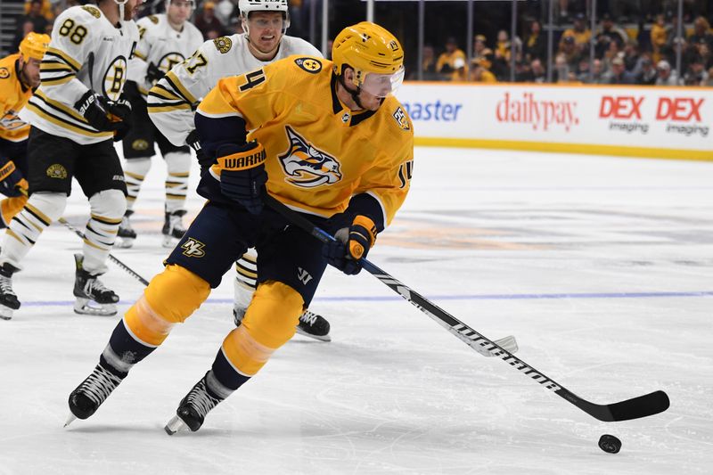 Apr 2, 2024; Nashville, Tennessee, USA; Nashville Predators center Gustav Nyquist (14) skates the puck toward the net during the third period against the Boston Bruins at Bridgestone Arena. Mandatory Credit: Christopher Hanewinckel-USA TODAY Sports