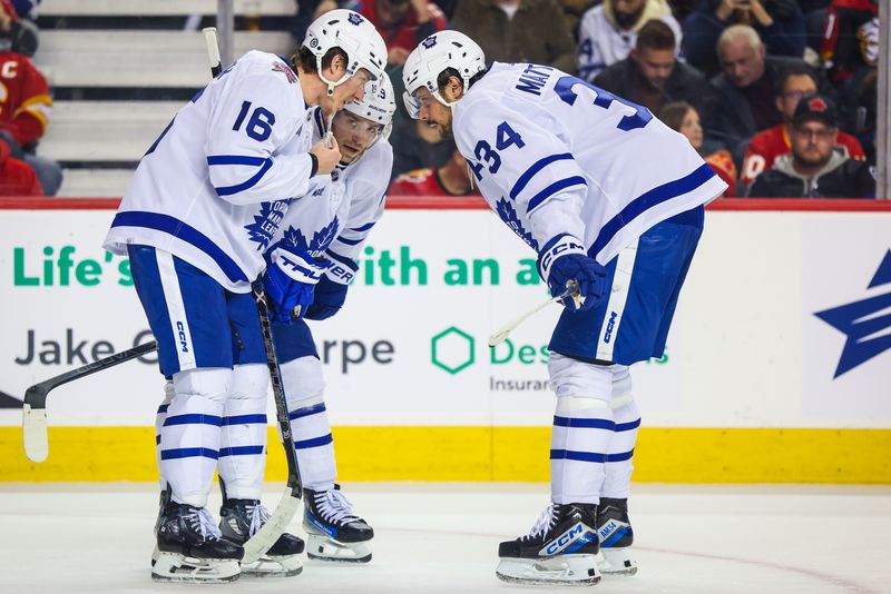 Jan 18, 2024; Calgary, Alberta, CAN; Toronto Maple Leafs right wing Mitchell Marner (16) and center Auston Matthews (34) exchanges words during the third period against the Calgary Flames at Scotiabank Saddledome. Mandatory Credit: Sergei Belski-USA TODAY Sports