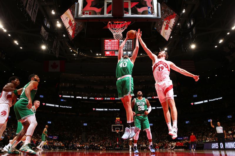 TORONTO, CANADA - OCTOBER 15: Luke Kornet #40 of the Boston Celtics grabs the rebound during the game against the Toronto Raptors on October 15, 2024 at the Scotiabank Arena in Toronto, Ontario, Canada.  NOTE TO USER: User expressly acknowledges and agrees that, by downloading and or using this Photograph, user is consenting to the terms and conditions of the Getty Images License Agreement.  Mandatory Copyright Notice: Copyright 2024 NBAE (Photo by Vaughn Ridley/NBAE via Getty Images)