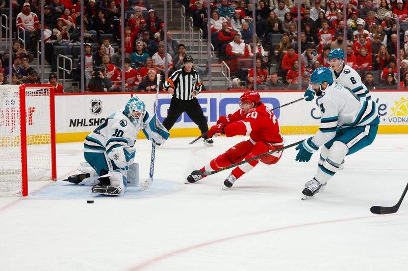Jan 16, 2026; Detroit, Michigan, USA; Detroit Red Wings defenseman Albert Johansson (20) is defended by San Jose Sharks defensemen Sam Dickinson (6) and Nick Leddy (4) as he takes a shot on goaltender Yaroslav Askarov (30) during the second period at Little Caesars Arena. Mandatory Credit: Brian Bradshaw Sevald-Imagn Images