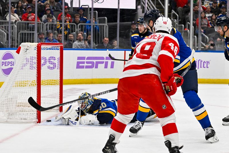 Dec 12, 2023; St. Louis, Missouri, USA;  Detroit Red Wings right wing Jonatan Berggren (48) scores against St. Louis Blues goaltender Jordan Binnington (50) during the first period at Enterprise Center. Mandatory Credit: Jeff Curry-USA TODAY Sports