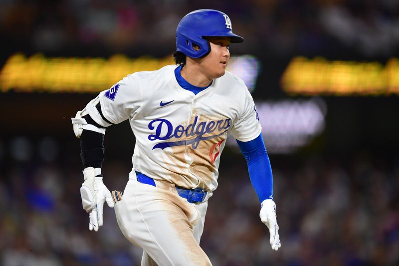 Aug 19, 2024; Los Angeles, California, USA; Los Angeles Dodgers designated hitter Shohei Ohtani (17) runs out a ground ball against the Seattle Mariners during the sixth inning at Dodger Stadium. Mandatory Credit: Gary A. Vasquez-USA TODAY Sports