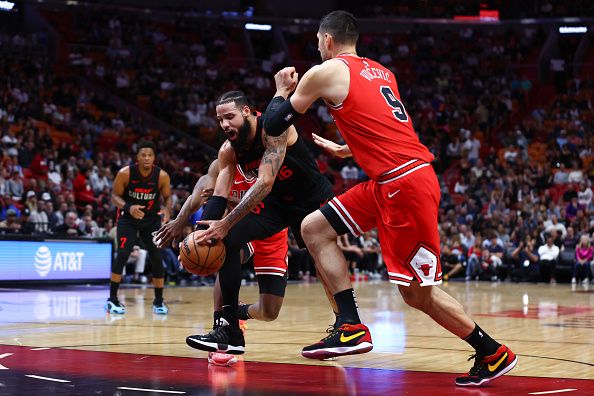 MIAMI, FLORIDA - DECEMBER 16: Caleb Martin #16 of the Miami Heat drives against Nikola Vucevic #9 of the Chicago Bulls during the first quarter of the game at Kaseya Center on December 16, 2023 in Miami, Florida. NOTE TO USER: User expressly acknowledges and agrees that, by downloading and or using this photograph, User is consenting to the terms and conditions of the Getty Images License Agreement. (Photo by Megan Briggs/Getty Images)