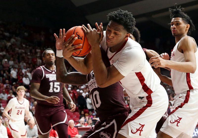 Feb 3, 2024; Tuscaloosa, Alabama, USA; Alabama forward Mouhamed Dioubate (10) and Mississippi State guard Dashawn Davis (10) struggle to control a rebound at Coleman Coliseum. Mandatory Credit: Gary Cosby Jr.-USA TODAY Sports