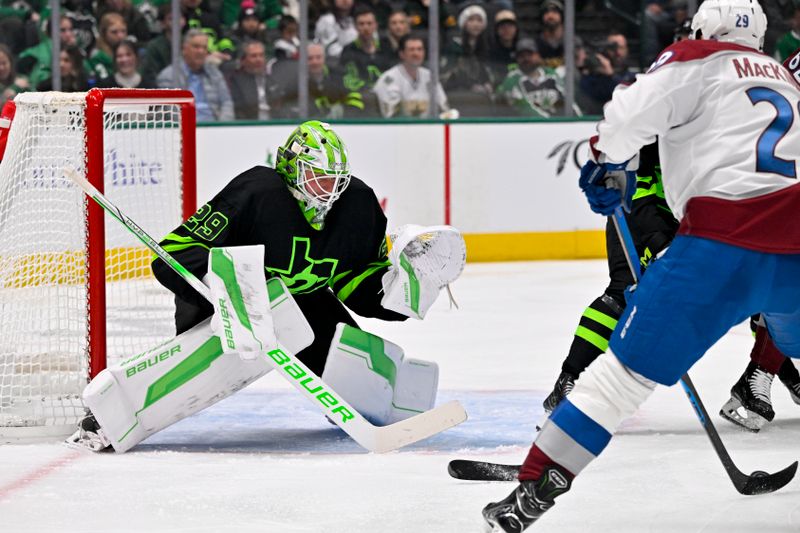 Nov 29, 2024; Dallas, Texas, USA; Dallas Stars goaltender Jake Oettinger (29) faces a shot by Colorado Avalanche center Nathan MacKinnon (29) during the third period at the American Airlines Center. Mandatory Credit: Jerome Miron-Imagn Images