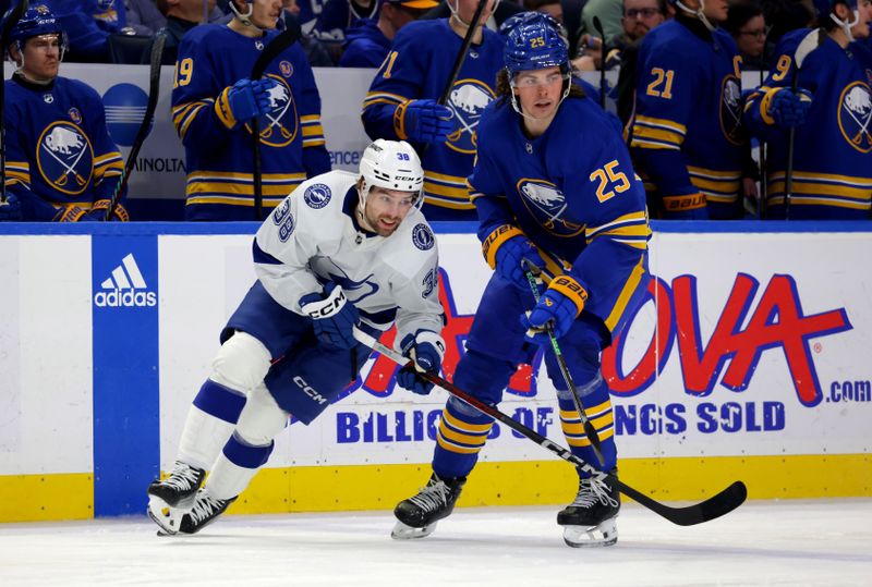 Jan 20, 2024; Buffalo, New York, USA;  Tampa Bay Lightning left wing Brandon Hagel (38) and Buffalo Sabres defenseman Owen Power (25) look for the puck during the third period at KeyBank Center. Mandatory Credit: Timothy T. Ludwig-USA TODAY Sports