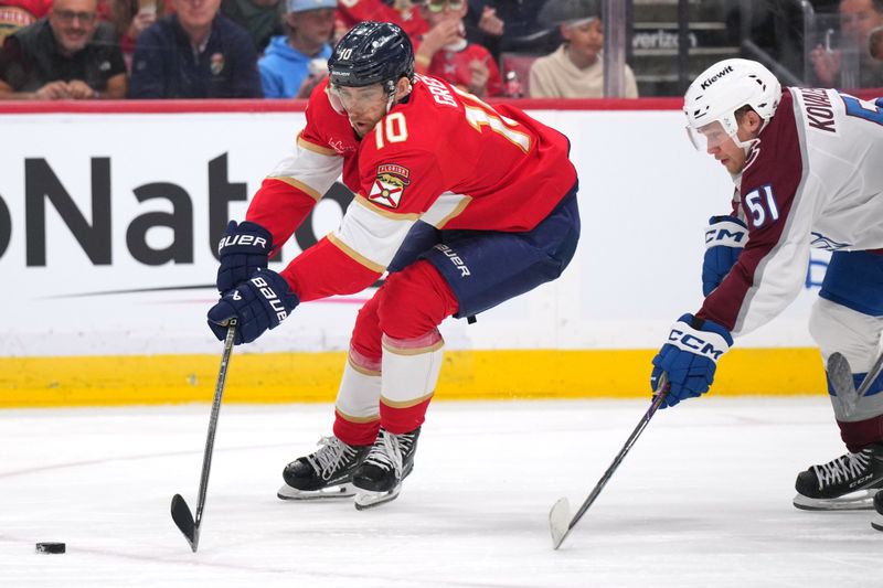 Nov 23, 2024; Sunrise, Florida, USA;  Florida Panthers left wing A.J. Greer (10) battles for position as Colorado Avalanche right wing Nikolai Kovalenko (51) closes in during the second period at Amerant Bank Arena. Mandatory Credit: Jim Rassol-Imagn Images