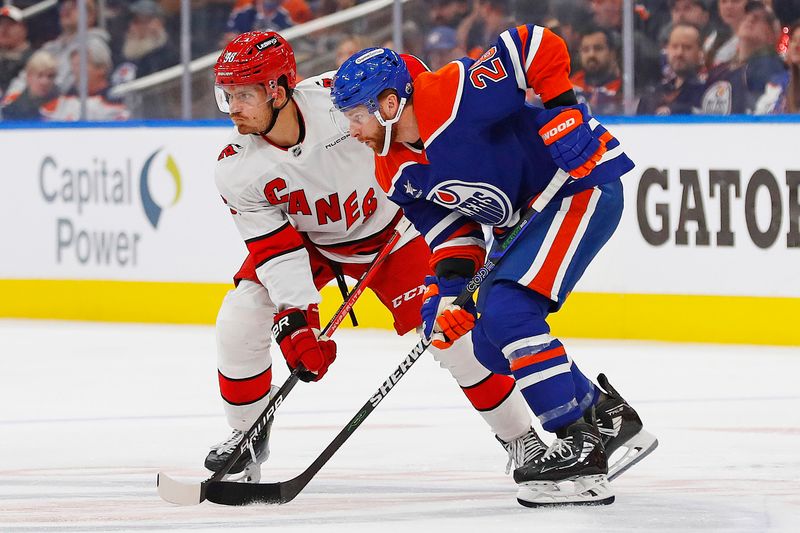 Oct 22, 2024; Edmonton, Alberta, CAN; Edmonton Oilers forward Connor Brown (28) and Carolina Hurricanes forward Jack Roslovic (96) battle for position during the second period at Rogers Place. Mandatory Credit: Perry Nelson-Imagn Images