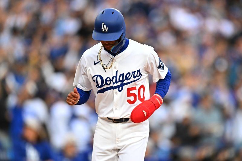 May 17, 2025; Los Angeles, California, USA;  Los Angeles Dodgers shortstop Mookie Betts (50) runs home to score a run against the Los Angeles Angels in the first inning at Dodger Stadium. Mandatory Credit: Jonathan Hui-Imagn Images
