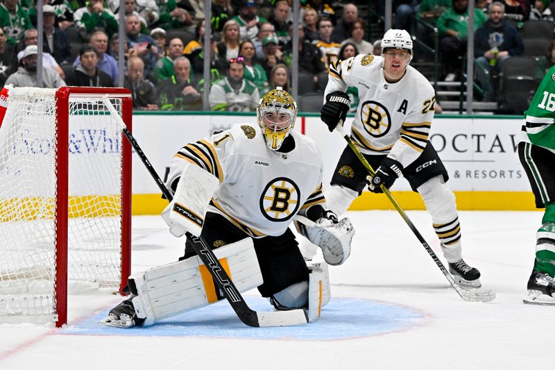 Nov 6, 2023; Dallas, Texas, USA; Boston Bruins goaltender Jeremy Swayman (1) and defenseman Hampus Lindholm (27) faces the Dallas Stars attack during the second period at the American Airlines Center. Mandatory Credit: Jerome Miron-USA TODAY Sports