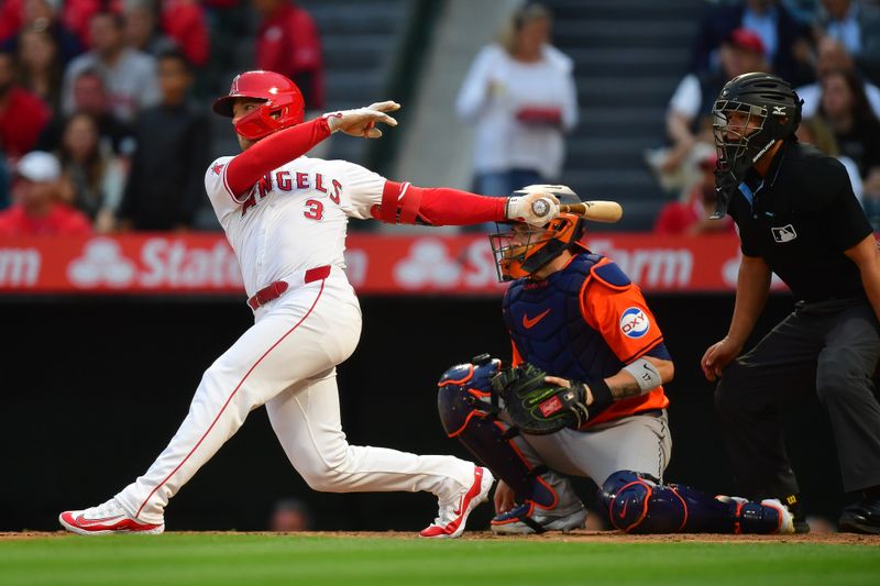 Jun 7, 2024; Anaheim, California, USA; Los Angeles Angels outfielder Taylor Ward (3) hits a single against the Houston Astros during the fourth inning at Angel Stadium. Mandatory Credit: Gary A. Vasquez-USA TODAY Sports