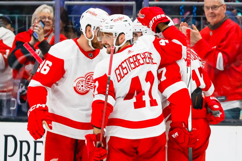 Feb 19, 2024; Seattle, Washington, USA; Detroit Red Wings defenseman Shayne Gostisbehere (41) celebrates a goal by right wing Daniel Sprong (17, right) against the Seattle Kraken during the second period at Climate Pledge Arena. Mandatory Credit: Joe Nicholson-USA TODAY Sports