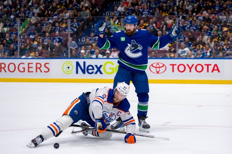 May 20, 2024; Vancouver, British Columbia, CAN; Vancouver Canucks defenseman Filip Hronek (17) checks Edmonton Oilers forward Connor McDavid (97) during the second period in game seven of the second round of the 2024 Stanley Cup Playoffs at Rogers Arena. Mandatory Credit: Bob Frid-USA TODAY Sports