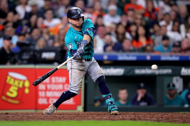 May 5, 2024; Houston, Texas, USA; Seattle Mariners third baseman Luis Urias (16) hits an RBI single against the Houston Astros during the eighth inning at Minute Maid Park. Mandatory Credit: Erik Williams-USA TODAY Sports
