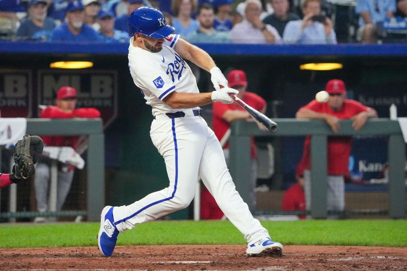 Aug 19, 2024; Kansas City, Missouri, USA; Kansas City Royals third baseman Paul DeJong (15) hits a two-run home run against the Los Angeles Angels in the fourth inning at Kauffman Stadium. Mandatory Credit: Denny Medley-USA TODAY Sports