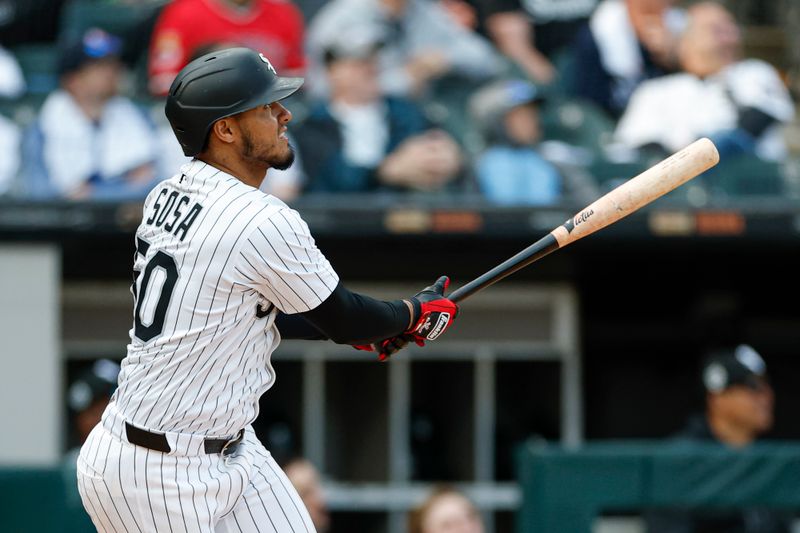 May 24, 2025; Chicago, Illinois, USA; Chicago White Sox second baseman Lenyn Sosa (50) hits a three-run double against the Texas Rangers during the sixth inning at Rate Field. Mandatory Credit: Kamil Krzaczynski-Imagn Images