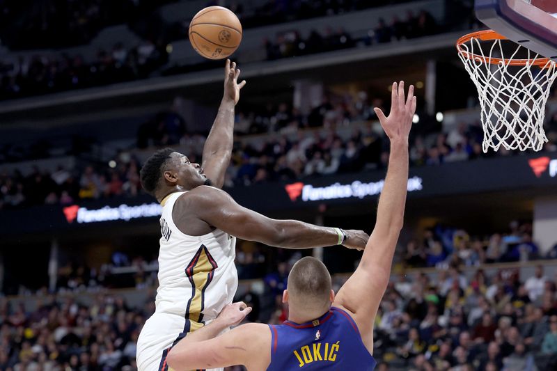 DENVER, COLORADO - JANUARY 12: Zion Williamson #1 of the New Orleans Pelicans goes to the basket against Nikola Jokic #15 of the Denver Nuggets in the fourth quarter at Ball Arena on January 12, 2024 in Denver, Colorado. NOTE TO USER: User expressly acknowledges and agrees that, by downloading and or using this photograph, User is consenting to the terms and conditions of the Getty Images License Agreement.  (Photo by Matthew Stockman/Getty Images)