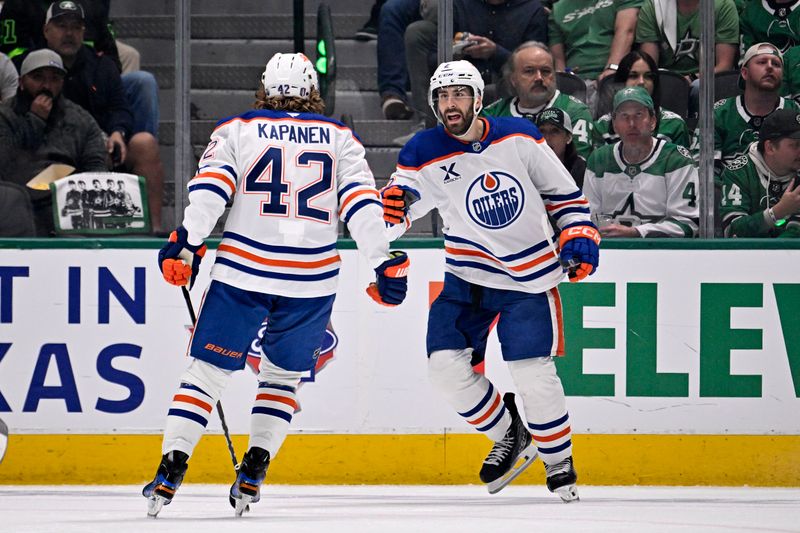 May 21, 2025; Dallas, Texas, USA; Edmonton Oilers defenseman Evan Bouchard (2) reacts with right wing Kasperi Kapanen (42) after scoring a goal against the Dallas Stars in the second period during game one of the Western Conference Final of the 2025 Stanley Cup Playoffs at American Airlines Center. Mandatory Credit: Jerome Miron-Imagn Images