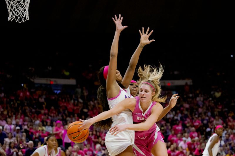 Feb 11, 2024; Baton Rouge, Louisiana, USA; Alabama Crimson Tide guard Sarah Ashlee Barker (3) passes around LSU Lady Tigers forward Angel Reese (10) and  guard Aneesah Morrow (24) during the second half at Pete Maravich Assembly Center. Mandatory Credit: Matthew Hinton-USA TODAY Sports