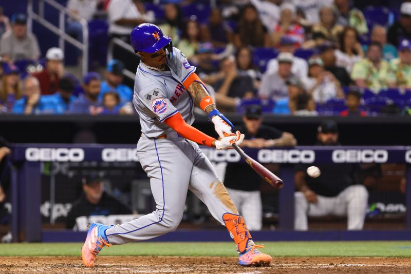 Jul 21, 2024; Miami, Florida, USA; New York Mets third baseman Mark Vientos (27) hits a single against the Miami Marlins during the fourth inning at loanDepot Park. Mandatory Credit: Sam Navarro-USA TODAY Sports