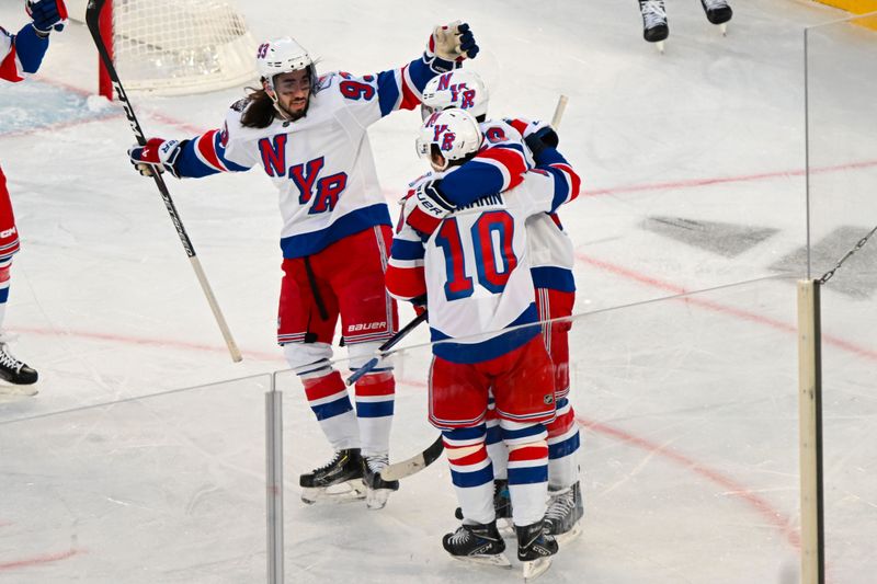 Feb 18, 2024; East Rutherford, New Jersey, USA;  New York Rangers left wing Artemi Panarin (10) celebrates his goal against the New York Islanders with New York Rangers center Mika Zibanejad (93) during the second period in a Stadium Series ice hockey game at MetLife Stadium. Mandatory Credit: Dennis Schneidler-USA TODAY Sports