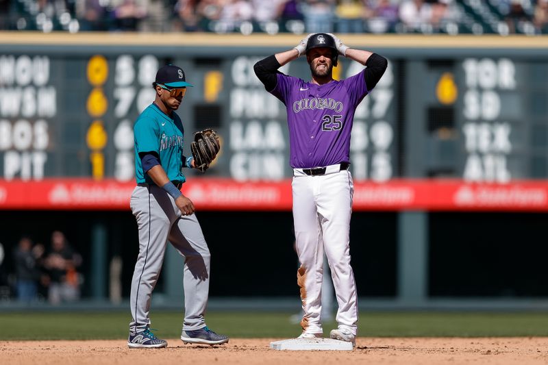 Apr 21, 2024; Denver, Colorado, USA; Colorado Rockies catcher Jacob Stallings (25) reacts ahead of Seattle Mariners second baseman Jorge Polanco (7) after a play in the ninth inning at Coors Field. Mandatory Credit: Isaiah J. Downing-USA TODAY Sports