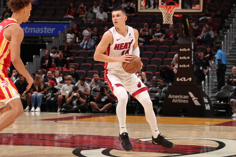 MIAMI, FL - OCTOBER 16: Tyler Herro #14 of the Miami Heat looks to pass the ball during the game against the Atlanta Hawks  on October 16, 2024 at Miami-Dade Arena in Miami, Florida. NOTE TO USER: User expressly acknowledges and agrees that, by downloading and or using this Photograph, user is consenting to the terms and conditions of the Getty Images License Agreement. Mandatory Copyright Notice: Copyright 2024 NBAE (Photo by Issac Baldizon/NBAE via Getty Images)