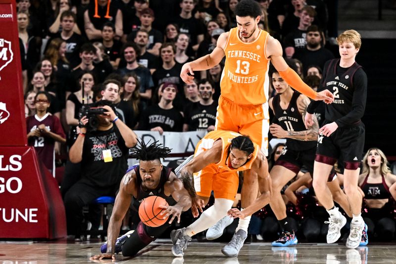 Feb 21, 2023; College Station, Texas, USA;  Tennessee Volunteers guard Zakai Zeigler (5) and Texas A&M Aggies forward Julius Marble (34) fight for a loose ball during the first half at Reed Arena. Mandatory Credit: Maria Lysaker-USA TODAY Sports