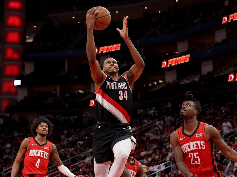 HOUSTON, TEXAS - MARCH 25: Jabari Walker #34 of the Portland Trail Blazers drives the lane in the first half against the Houston Rockets at Toyota Center on March 25, 2024 in Houston, Texas.  NOTE TO USER: User expressly acknowledges and agrees that, by downloading and or using this photograph, User is consenting to the terms and conditions of the Getty Images License Agreement. (Photo by Tim Warner/Getty Images)