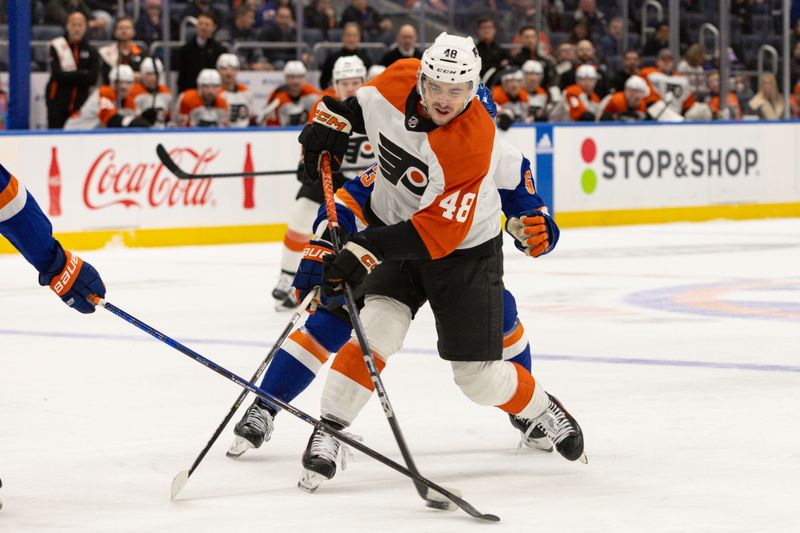 Nov 25, 2023; Elmont, New York, USA; Philadelphia Flyers center Morgan Frost (48) takes a shot against the New York Islanders during the first period at UBS Arena. Mandatory Credit: Thomas Salus-USA TODAY Sports