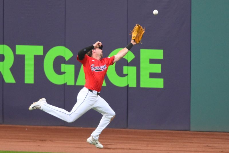 Jul 3, 2024; Cleveland, Ohio, USA; Cleveland Guardians center field Daniel Schneemann (10) reaches for the ball on a hit by the Chicago White Sox in the fourth inning at Progressive Field. Mandatory Credit: David Richard-USA TODAY Sports