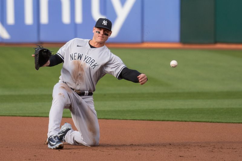 Jun 27, 2023; Oakland, California, USA; New York Yankees first baseman Anthony Rizzo (48) throws the ball from his knees during the first inning against the Oakland Athletics at Oakland-Alameda County Coliseum. Mandatory Credit: Ed Szczepanski-USA TODAY Sports