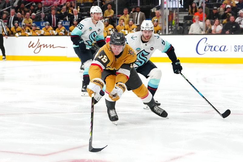 Apr 10, 2025; Las Vegas, Nevada, USA; Vegas Golden Knights left wing Pavel Dorofeyev (16) reaches for the puck in front of Seattle Kraken center Shane Wright (51) during the second period at T-Mobile Arena. Mandatory Credit: Stephen R. Sylvanie-Imagn Images