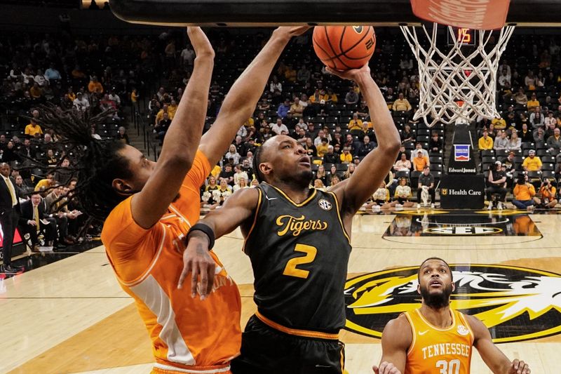 Feb 20, 2024; Columbia, Missouri, USA; Missouri Tigers guard Tamar Bates (2) shoots as Tennessee Volunteers forward Jonas Aidoo (0) defends during the first half at Mizzou Arena. Mandatory Credit: Denny Medley-USA TODAY Sports