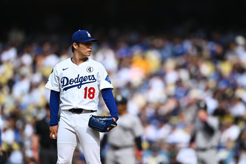 Jun 1, 2025; Los Angeles, California, USA;  Los Angeles Dodgers starting pitcher Yoshinobu Yamamoto (18) on the mound against the New York Yankees during the first inning at Dodger Stadium. Mandatory Credit: Jonathan Hui-Imagn Images
