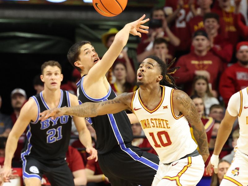 Mar 4, 2025; Ames, Iowa, USA; Brigham Young Cougars guard Egor Demin (3) and Iowa State Cyclones guard Keshon Gilbert (10) battle for a lose ball at James H. Hilton Coliseum. Mandatory Credit: Reese Strickland-Imagn Images