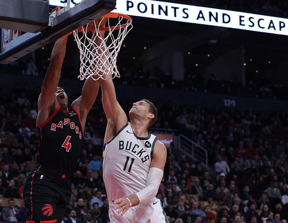 TORONTO, ON- NOVEMBER 15  - Toronto Raptors forward Scottie Barnes (4) dunks as Milwaukee Bucks center Brook Lopez (11) defends as the Toronto Raptors fall to the Milwaukee Bucks 128-112 at Scotiabank Arena in Toronto. November 15, 2023.        (Steve Russell/Toronto Star via Getty Images)