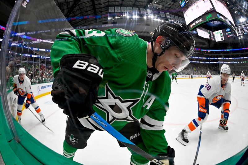 Feb 26, 2024; Dallas, Texas, USA; Dallas Stars defenseman Esa Lindell (23) looks for the puck along the boards during the game against the New York Islanders at the American Airlines Center. Mandatory Credit: Jerome Miron-USA TODAY Sports