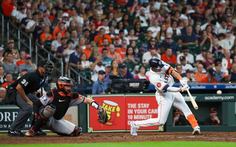 Jun 23, 2024; Houston, Texas, USA;  Houston Astros shortstop Jeremy Pena (3) hits a RBI double against the Baltimore Orioles in the sixth inning at Minute Maid Park. Mandatory Credit: Thomas Shea-USA TODAY Sports