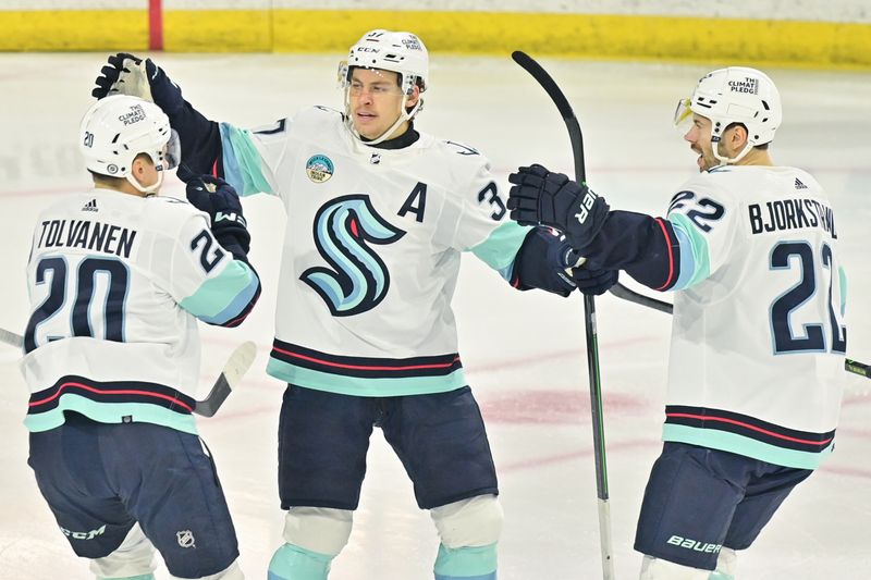 Nov 7, 2023; Tempe, Arizona, USA; Seattle Kraken right wing Eeli Tolvanen (20) celebrates with center Yanni Gourde (37) and right wing Oliver Bjorkstrand (22) after scoring a goal in the first period against the Arizona Coyotes at Mullett Arena. Mandatory Credit: Matt Kartozian-USA TODAY Sports