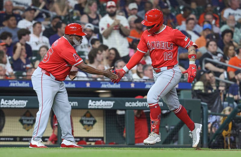May 21, 2024; Houston, Texas, USA; Los Angeles Angels center fielder Kevin Pillar (12) celebrates with third base coach Eric Young Sr. (85) after hitting a home run during the seventh inning against the Houston Astros at Minute Maid Park. Mandatory Credit: Troy Taormina-USA TODAY Sports
