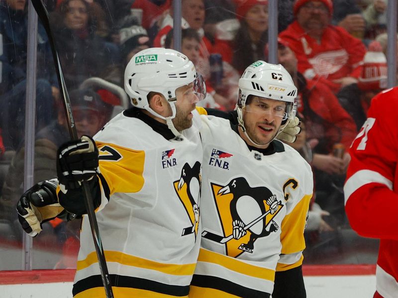Jan 3, 2026; Detroit, Michigan, USA; Pittsburgh Penguins center Sidney Crosby (87) celebrates a goal scored in the first period with right wing Bryan Rust (17) during the first periodat Little Caesars Arena. Mandatory Credit: Brian Bradshaw Sevald-Imagn Images